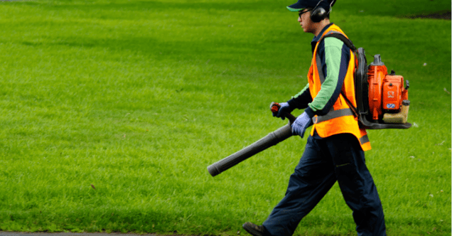 Landscaper using a leaf blower on yard