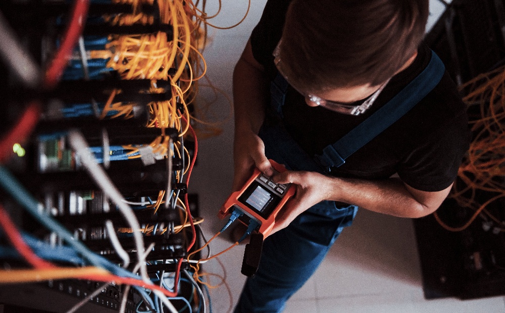 young-man-in-uniform-works-in-server-room-2023-11-27-04-53-52-utc-1